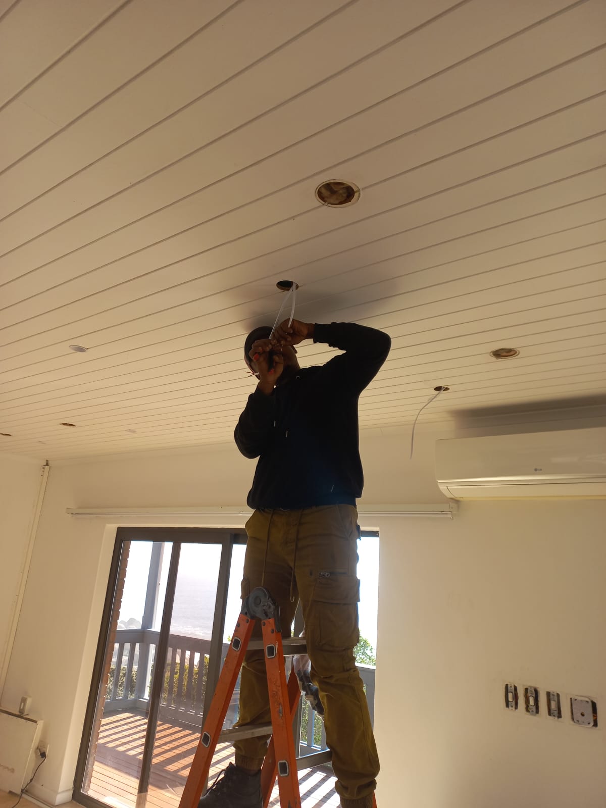AirTech Solution Systems electrician installing recessed downlights on site