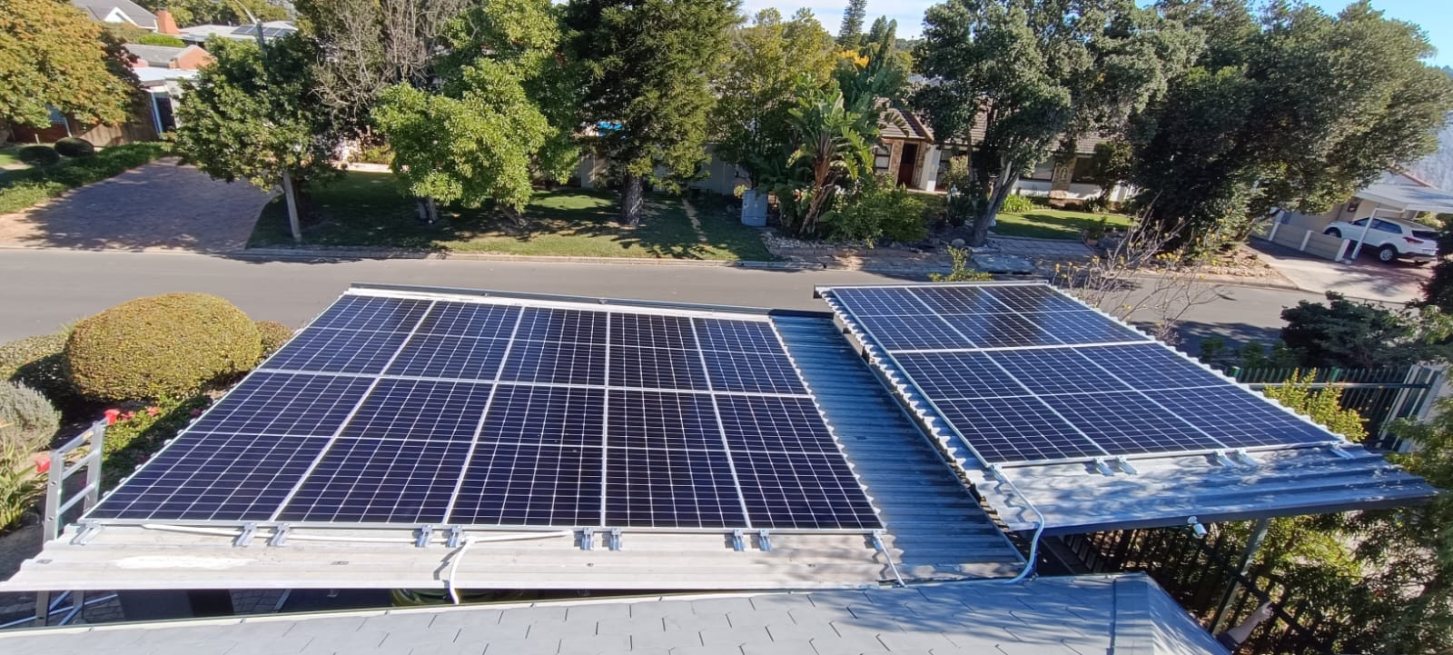 Aerial view of residential rooftop solar panels installed on a corrugated roof
